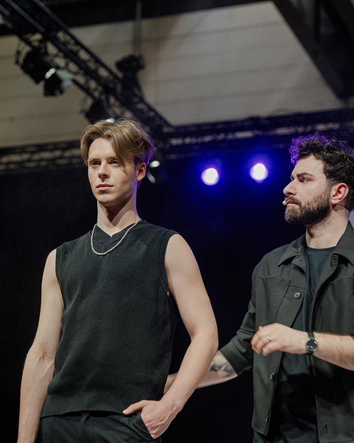 Männliches Model mit moderner Frisur und dem Hairstylisten auf einer Bühne der TOP HAIR 2025 für die Kollektion Urban Code von Wahl Professional